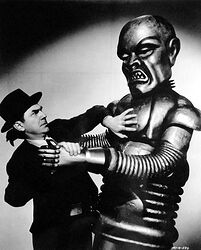 Scene from 1939 movie "Phantom Creeps" with evil bot grabbing a person